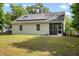 Backyard of house with solar panels and a screened in porch at 1578 Stanwick Dr, Johns Island, SC 29455