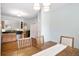 Bright dining area with hardwood floors, a wooden table, and a seamless transition to the kitchen at 1578 Stanwick Dr, Johns Island, SC 29455