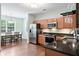 Bright kitchen with stainless steel appliances, granite countertops, hardwood floors, and adjacent dining area at 1578 Stanwick Dr, Johns Island, SC 29455