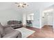 Cozy living room featuring hardwood floors, a comfortable seating arrangement, and a clear view to the kitchen at 1578 Stanwick Dr, Johns Island, SC 29455