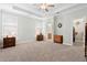 Spacious main bedroom with tray ceiling, carpet, and ensuite bathroom and walk-in closet at 1578 Stanwick Dr, Johns Island, SC 29455