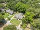 Stunning aerial view of a brick home with a well-manicured lawn and mature trees at 1593 Teague St, Charleston, SC 29407