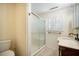 Bathroom with a shower, vanity with marble countertop, and a window with plantation shutters at 1593 Teague St, Charleston, SC 29407