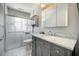 Modern bathroom with a gray vanity, marble countertop, glass shower, and updated fixtures at 1593 Teague St, Charleston, SC 29407