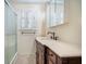 Bathroom featuring a vanity with marble countertop, elegant fixtures, and a glass-enclosed shower at 1593 Teague St, Charleston, SC 29407
