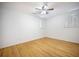 Simple bedroom featuring hardwood floors, a ceiling fan, and natural light from two windows at 1593 Teague St, Charleston, SC 29407