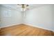 Cozy bedroom with hardwood floors, a ceiling fan, and natural light from two windows at 1593 Teague St, Charleston, SC 29407