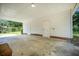 Covered carport area shows a well maintained concrete floor, multiple doors, and overhead lighting at 1593 Teague St, Charleston, SC 29407