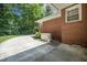 The exterior of this brick home shows a concrete patio area and a backup generator at 1593 Teague St, Charleston, SC 29407