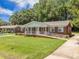 Charming red brick home with well-manicured lawn and inviting front porch at 1593 Teague St, Charleston, SC 29407