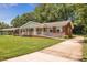 Well-maintained brick home with a manicured lawn, accessible ramp, and a welcoming front porch, perfect for curb appeal at 1593 Teague St, Charleston, SC 29407
