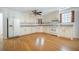 Traditional kitchen featuring white cabinets, hardwood floors, and ample counter space at 1593 Teague St, Charleston, SC 29407