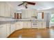 Traditional kitchen featuring white cabinets, hardwood floors, and ample counter space at 1593 Teague St, Charleston, SC 29407