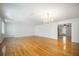 Bright living room with hardwood floors, chandelier, and natural light at 1593 Teague St, Charleston, SC 29407