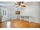 Well-lit living room with hardwood floors and a charming desk area, perfect for a home office setup at 1593 Teague St, Charleston, SC 29407
