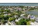 A picturesque aerial view overlooking houses with colorful roofs, lush trees, and a serene lake in the neighborhood at 16 Trumbo St, Charleston, SC 29401