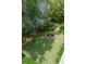 View of backyard featuring a stone fountain surrounded by a manicured lawn and landscaped borders at 16 Trumbo St, Charleston, SC 29401
