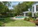 Relaxing pool area with a stone patio, surrounded by lush greenery and lounge chairs at 16 Trumbo St, Charleston, SC 29401