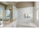 Bright bathroom with white tile, a vanity with a stone countertop, and a glass shower enclosure at 16 Trumbo St, Charleston, SC 29401
