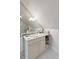 Compact bathroom with tiled floor, white vanity, and patterned wallpaper at 16 Trumbo St, Charleston, SC 29401