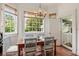Cozy breakfast nook with wooden table, stylish chairs, and large windows overlooking the outdoors at 16 Trumbo St, Charleston, SC 29401
