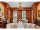 Dining room featuring wood-paneled walls, built-in bookshelves, and chandelier, ideal for elegant dining at 16 Trumbo St, Charleston, SC 29401