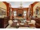 Dining room featuring wood-paneled walls, built-in bookshelves, and chandelier, ideal for elegant dining at 16 Trumbo St, Charleston, SC 29401