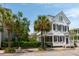 Charming home exterior featuring a well-manicured yard with palm trees and stylish architectural details at 16 Trumbo St, Charleston, SC 29401