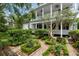 Two-story home showcasing lush landscaping and a charming garden area at 16 Trumbo St, Charleston, SC 29401