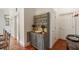 Hallway featuring terracotta tile flooring and antique decorative cabinet at 16 Trumbo St, Charleston, SC 29401