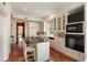 Spacious kitchen has an island with bar seating, white cabinetry, and stainless steel appliances at 16 Trumbo St, Charleston, SC 29401