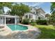 Gorgeous backyard with a sparkling pool, stone patio, and stylish home exterior at 16 Trumbo St, Charleston, SC 29401