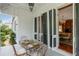 Outdoor dining area on covered porch, perfect for alfresco meals and entertaining with its inviting atmosphere at 16 Trumbo St, Charleston, SC 29401