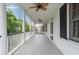 Spacious porch features columns, wood flooring, two ceiling fans, and ample room for outdoor seating at 16 Trumbo St, Charleston, SC 29401