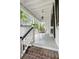 Relaxing outdoor porch with metal seating and classic white railings offers an inviting space to unwind at 16 Trumbo St, Charleston, SC 29401