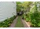 Charming brick-lined walkway with colorful hydrangea bushes and well-maintained lawn at 16 Trumbo St, Charleston, SC 29401