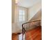 Hardwood staircase with white walls, a window, and a curved banister with wood spindles at 16 Trumbo St, Charleston, SC 29401