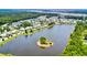 Aerial view of a pond with a small island surrounded by trees and houses at 1723 Bolden Dr, Mount Pleasant, SC 29466