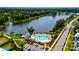 Aerial view of community pond near pool, parking lot, sidewalks and homes surrounded by a forest at 1723 Bolden Dr, Mount Pleasant, SC 29466
