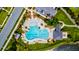 Aerial view of community pool featuring lounge chairs, umbrellas, landscaping, shade structure and parking lot at 1723 Bolden Dr, Mount Pleasant, SC 29466
