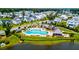 Community pool surrounded by houses, landscaping and trees near a pond in a neighborhood with walking trails at 1723 Bolden Dr, Mount Pleasant, SC 29466