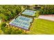 Aerial view of four fenced community tennis courts surrounded by trees and sidewalks at 1723 Bolden Dr, Mount Pleasant, SC 29466