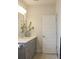 Bathroom with a gray vanity, white countertop, patterned floor, and a classic white paneled door at 1723 Bolden Dr, Mount Pleasant, SC 29466
