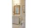 Well-lit bathroom featuring a vanity with a wicker-framed mirror and elegant tile flooring at 1723 Bolden Dr, Mount Pleasant, SC 29466