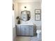 Bathroom features a gray vanity with white countertop, decorative mirror, and patterned tile flooring at 1723 Bolden Dr, Mount Pleasant, SC 29466