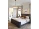 Well-lit bedroom featuring a patterned rug and stylish light fixture, adjacent to an ensuite bathroom at 1723 Bolden Dr, Mount Pleasant, SC 29466