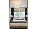 Beautiful bedroom featuring a large bed, stylish lighting, and dark curtains framing bright windows at 1723 Bolden Dr, Mount Pleasant, SC 29466