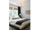Comfortable bedroom featuring a queen bed, stylish lighting, and windows overlooking the yard at 1723 Bolden Dr, Mount Pleasant, SC 29466