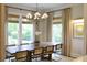 Dining room with a large wooden table surrounded by seating, complemented by natural light from the windows at 1723 Bolden Dr, Mount Pleasant, SC 29466