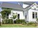 Well-maintained exterior with white siding, black framed windows and lush landscaping at 1723 Bolden Dr, Mount Pleasant, SC 29466